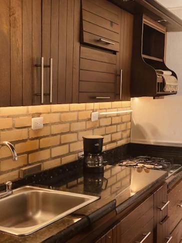 a kitchen with a sink and a counter top at La Casona Santa Fe in Santa Fe de Antioquia