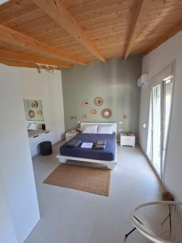 a bedroom with a bed and a wooden ceiling at Alexander studio in Spartià