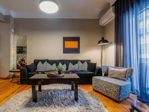 a living room with a couch and a table at 4 TRAVELERS Together in Thessaloniki