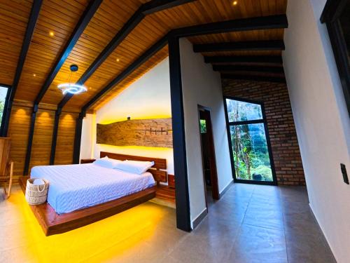 a bedroom with a large bed in a house at Kilamo sky glamping macas in Macas
