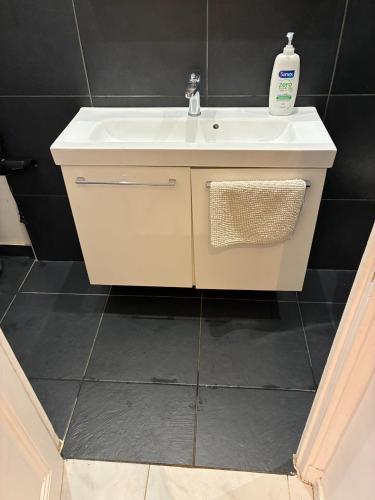 a bathroom with a white sink and a mirror at Monaco Studio #3 with private patio in Beausoleil