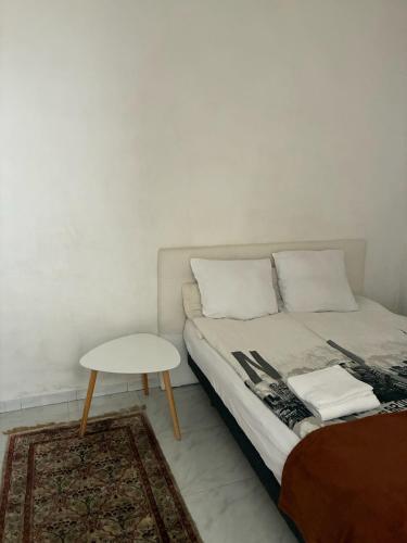 a bedroom with a bed and a small table at Monaco Studio #3 with private patio in Beausoleil