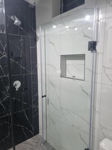 a bathroom with a shower with a glass door at Misky Samana Hotel in Espinar