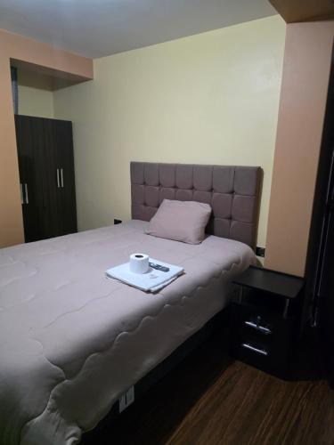 a bed with a tray with a cup on it at Misky Samana Hotel in Espinar