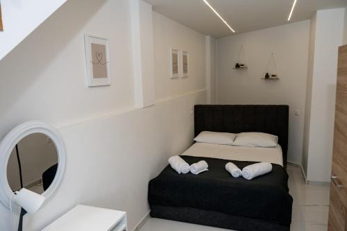 a small bedroom with a bed and a mirror at Angels luxury villa in Kastamonítsa