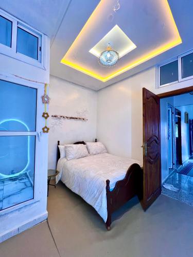 a bedroom with a bed and a large window at velaris in Chefchaouen