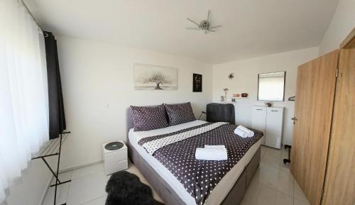 a bedroom with a bed and a dog in it at APARTMÁNY I&V - Adults Only in Pilsen