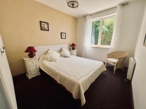 a bedroom with a bed and a window at La Maison d Ingrandes - relais Valami in Ingrandes-de-Touraine