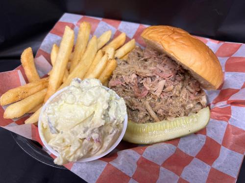 a sandwich and french fries with coleslaw and a pickle at Dragon City in Maryville