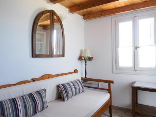 a white room with a bench and a mirror at Anemoessa Studios in Pollonia