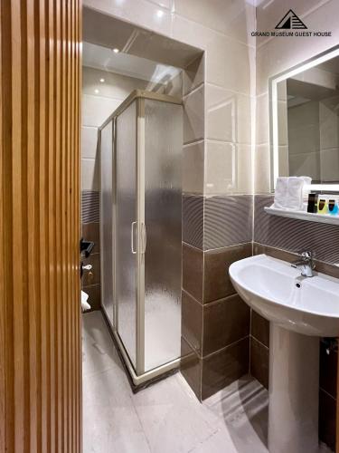 a bathroom with a shower and a sink at Grand Museum with Pyramids view inn in Cairo