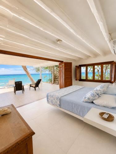 a bedroom with a bed and a view of the ocean at Isla Risa in Cartagena de Indias