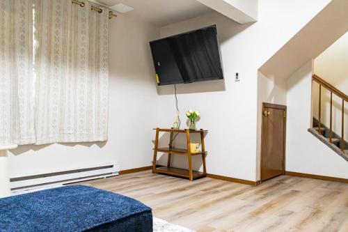 a living room with a flat screen tv on the wall at Cozy house in Moorhead