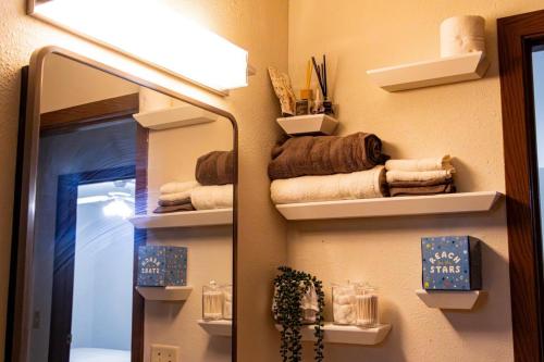 a bathroom with a mirror and a lamp and towels at Cozy house in Moorhead