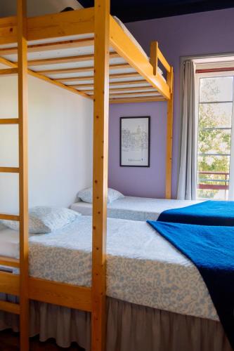 two bunk beds in a room with a window at Most Art Boutique Hostel in Leiria
