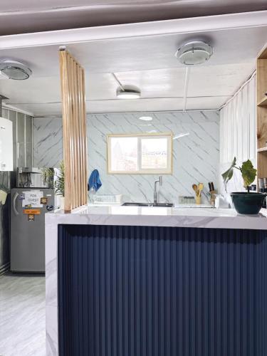 a kitchen with a sink and a counter top at Hostel 53 Sur in Puerto Natales