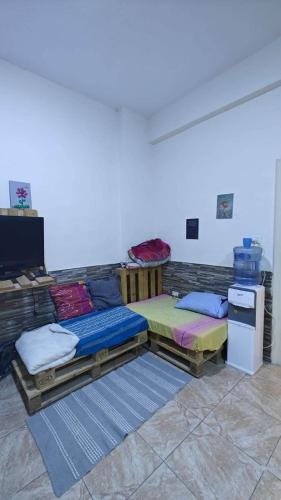 a room with two beds and a refrigerator at Egypt holiday in Alexandria