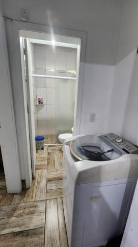 a small bathroom with a toilet and a sink at Casa com piscina e próxima ao mar em Imbe in Imbé