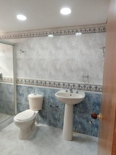 a bathroom with a toilet and a sink at Villa del Tesoro in El Poblado
