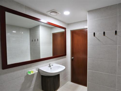 a bathroom with a sink and a mirror at Hotel La ISRA at Kuala Lumpur in Kuala Lumpur