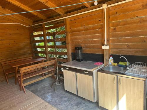 a kitchen with a bench and a sink in a cabin at Bojana Breeze in Ulcinj