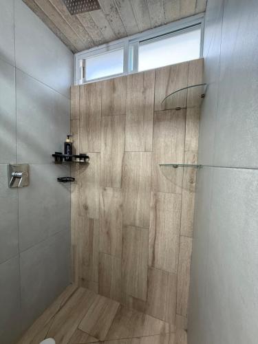 a bathroom with a shower with a glass door at Lovely chalet in Mazamitla in Puente de las Cuevas