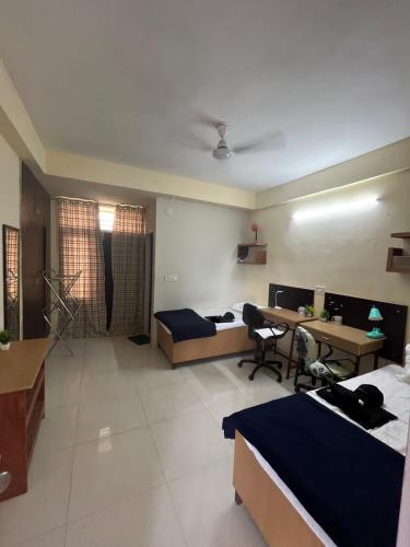 a room with two beds and a desk and a table at Hotel New Imperial inn in Chhatikara