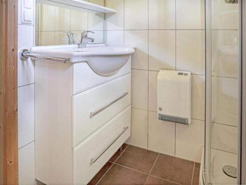 a white bathroom with a sink and a shower at Sjenharieja in Stadl an der Mur