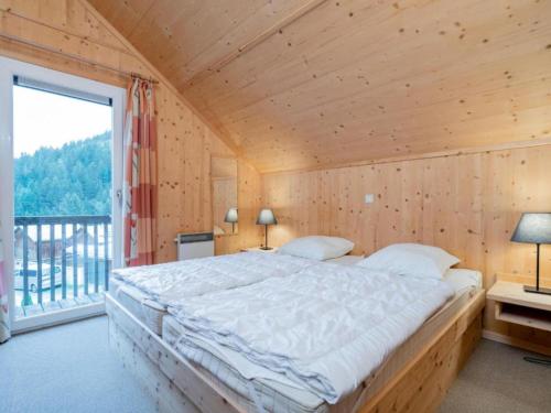 a bedroom with a large bed and a large window at Baier in Stadl an der Mur