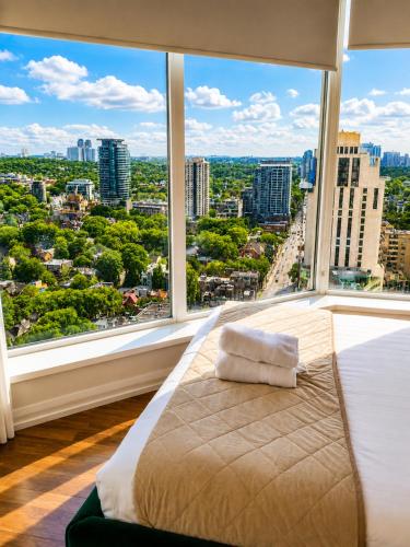a large bed in a room with a large window at Luxury 3-Beds Apartment in Yorkville with the Best City View in Downtown Toronto in Toronto