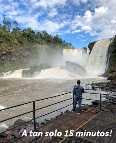 a man standing in front of a waterfall at Cómo en casa CDE in Ciudad del Este