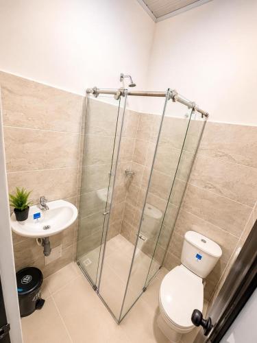 a bathroom with a shower and a toilet and a sink at hotel venus in Los Patios