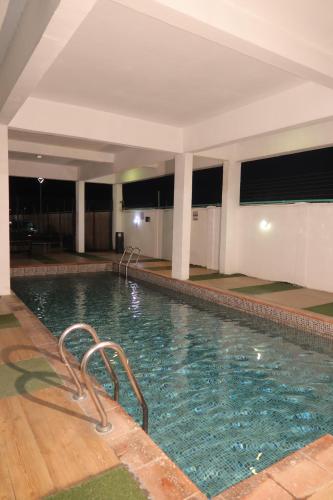 a large swimming pool in a building with at Maison Madame - Female only Shared Apartment Lekki in Lekki