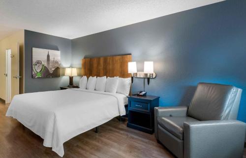 a bedroom with a large bed and a chair at Extended Stay America Suites - Washington, DC - Centreville - Manassas in Centreville