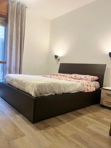 a bedroom with a bed and a dresser and a window at Dream Homes in Donnaz