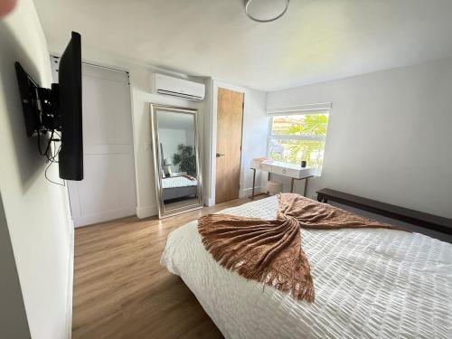 a bedroom with a large bed and a mirror at Private Suite with Laundry in Sunset