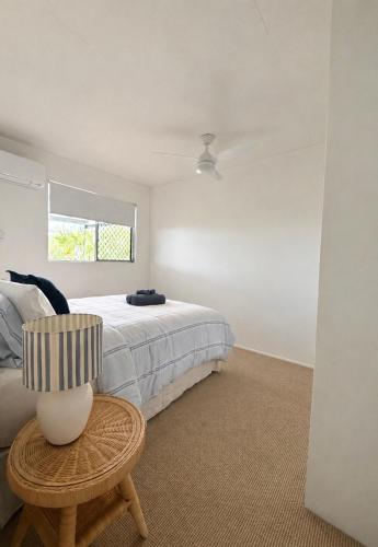 a bedroom with a bed and a chair and a window at 'The Station House' Mount Isa in Mount Isa