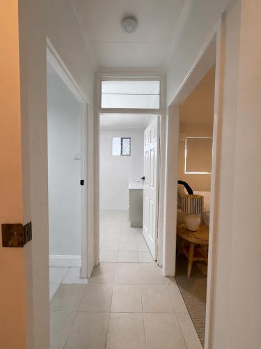 an empty hallway with a hallway leading to a room at 'The Station House' Mount Isa in Mount Isa