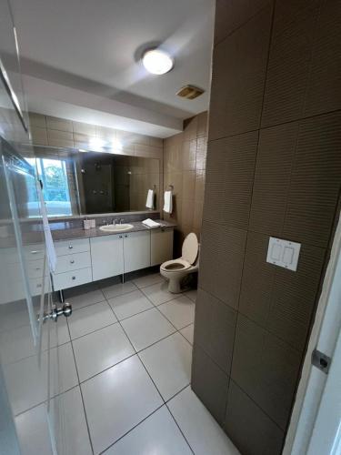 a bathroom with a toilet and a sink at Beach apartment on the seashore in Las Lajas