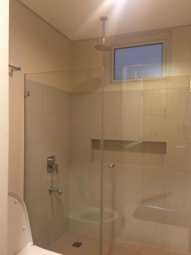 a glass shower in a bathroom with a toilet at 1BR Condo Unit in Pico De Loro in Nasugbu