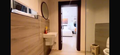 a bathroom with a toilet and a sink and a mirror at Orange Place - Benson Close in Lagos