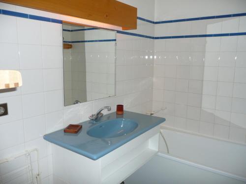 a bathroom with a blue sink and a tub at Saint-Roch Piste in Val dʼIsère