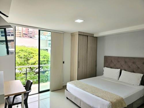 a hotel room with a bed and a balcony at 110 Loft in Cali