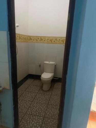 a bathroom with a toilet in a small room at Amed beach homestay in Ambat