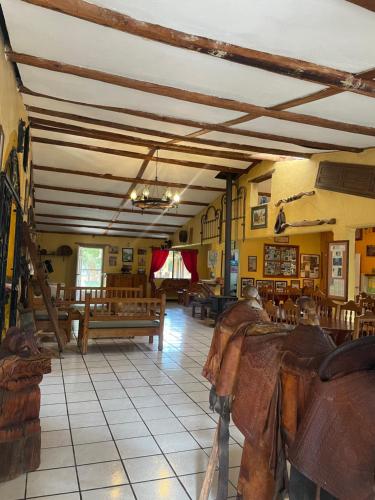 a room with tables and benches in a building at Hotel Paraiso del Oso in Cerocahui