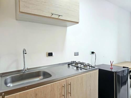 a kitchen with a sink and a stove at 110 Loft in Cali
