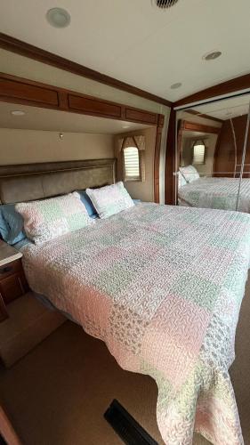 a bed in the middle of a room at Maggies Place in Ingonish