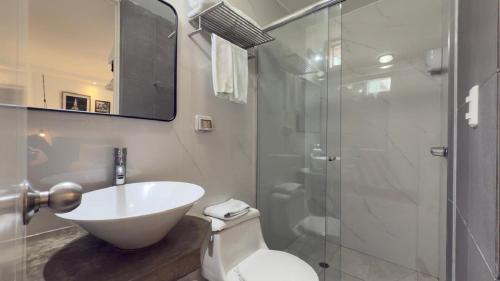 a bathroom with a white sink and a shower at La Casa del Viajero in Lima