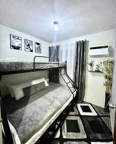 a room with two bunk beds in it at 2BR Condo with pool at Sorrento Oasis Pasig in Manila