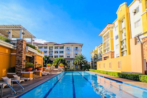 a swimming pool in the middle of two buildings at 2BR Condo with pool at Sorrento Oasis Pasig in Manila